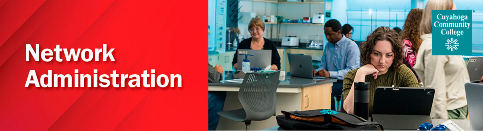 People in a room on laptops demonstrating network administration