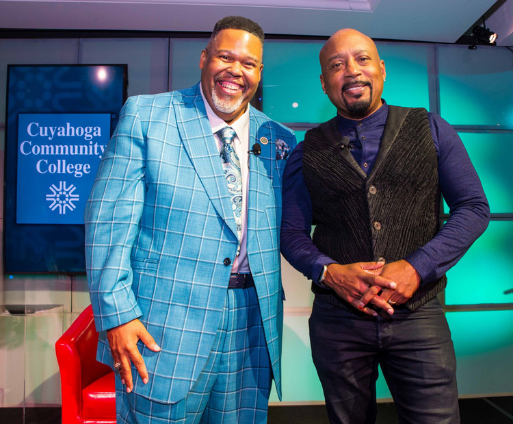 Tri-C President Michael Baston with Daymond John smiling onstage