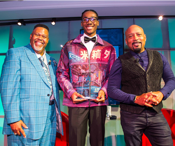 Photo of London Mitchell, center, with Tri-C President Michael A. Baston, J.D., Ed.D. (left), and Presidential Scholarship Luncheon speaker Daymond John