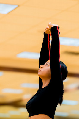 female dancer reaching upward with both arms