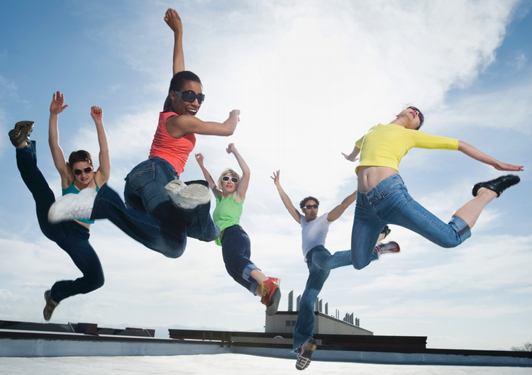 Dancers on rooftop jumping up 