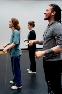 Dance teacher and two students doing popping technique