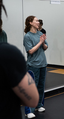 Female dance teacher smiling with hands together