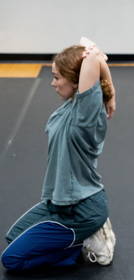 female dancer stretching arm behind head