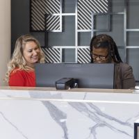 employees working at the front desk of a hotel